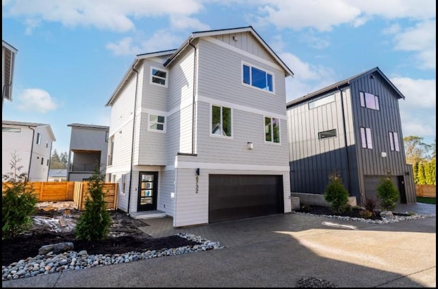 6730 21st Ave SW, Seattle, WA 98106 - view of front facade with an attached garage, board and batten siding, and driveway