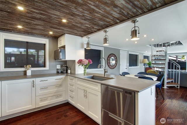 2401 N Northlake Way Unit B13, Seattle, WA 98103 - kitchen with stainless steel dishwasher, a peninsula, a sink, white cabinets, and wood ceiling