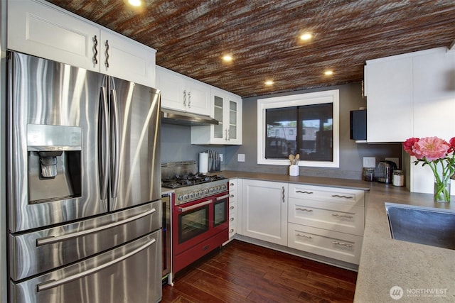 2401 N Northlake Way Unit B13, Seattle, WA 98103 - kitchen featuring appliances with stainless steel finishes, wood ceiling, under cabinet range hood, white cabinets, and glass insert cabinets