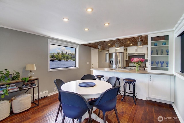 2401 N Northlake Way Unit B13, Seattle, WA 98103 - dining space with baseboard heating, dark wood-style flooring, baseboards, recessed lighting, and ornamental molding