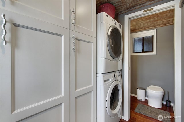 2401 N Northlake Way Unit B13, Seattle, WA 98103 - laundry area featuring stacked washing machine and dryer, dark wood-style floors, and baseboards