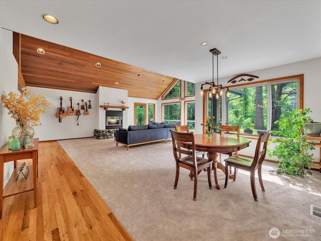 44611 SE 72nd St, Snoqualmie, WA 98065 - dining area with vaulted ceiling, recessed lighting, carpet floors, baseboards, and a glass covered fireplace