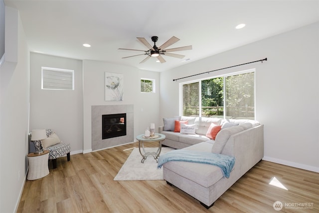 9422 Fairhaven Cir NE, Bremerton, WA 98311 - living room featuring wood finished floors, a ceiling fan, a tiled fireplace, recessed lighting, and baseboards