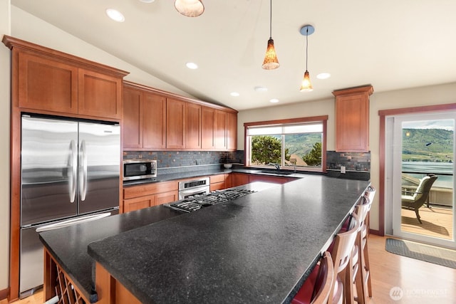 205 Butte Rd, Chelan, WA 98816 - kitchen with stainless steel appliances, backsplash, lofted ceiling, a center island, and recessed lighting