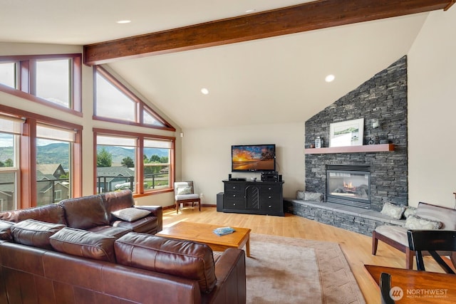 205 Butte Rd, Chelan, WA 98816 - living area with beam ceiling, high vaulted ceiling, wood finished floors, and a stone fireplace
