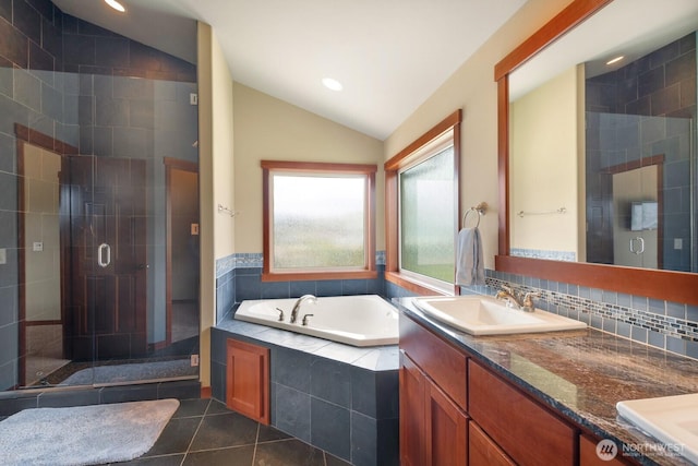 205 Butte Rd, Chelan, WA 98816 - full bathroom featuring lofted ceiling, a garden tub, double vanity, a stall shower, and tile patterned flooring