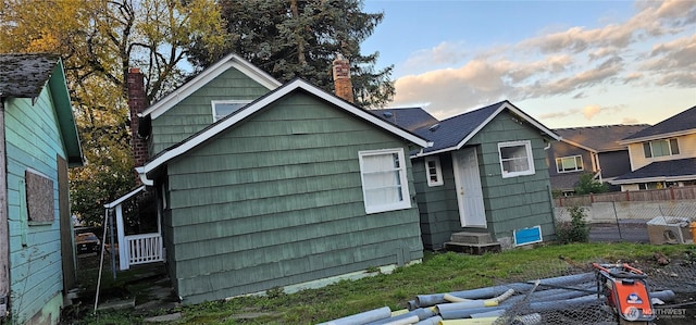 4641 S 144th St, Tukwila, WA 98168 - rear view of house with entry steps and a chimney