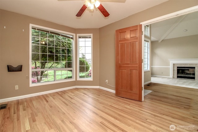 5318 Galleon Dr NE, Tacoma, WA 98422 - unfurnished living room featuring light wood-style floors, baseboards, ceiling fan, and a fireplace