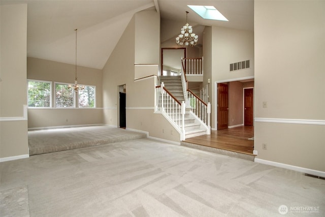 5318 Galleon Dr NE, Tacoma, WA 98422 - unfurnished living room featuring a chandelier, high vaulted ceiling, stairs, carpet flooring, and a skylight