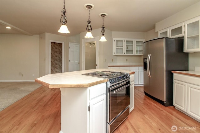 5318 Galleon Dr NE, Tacoma, WA 98422 - kitchen with range with electric stovetop, stainless steel refrigerator with ice dispenser, tile counters, a kitchen island, and glass insert cabinets