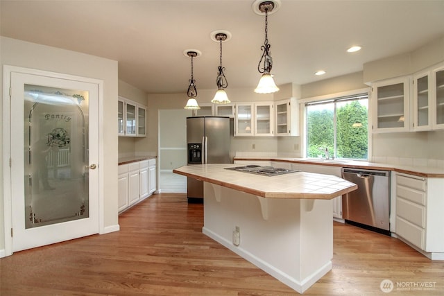 5318 Galleon Dr NE, Tacoma, WA 98422 - kitchen with stainless steel appliances, tile counters, a sink, white cabinetry, and light wood-type flooring