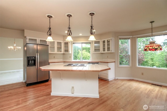 5318 Galleon Dr NE, Tacoma, WA 98422 - kitchen featuring stainless steel fridge, tile counters, a kitchen island, white cabinets, and light wood-type flooring