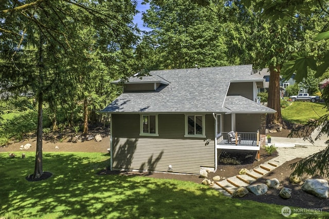 27302 NE 153rd Pl, Duvall, WA 98019 - view of property exterior featuring covered porch, a lawn, and roof with shingles