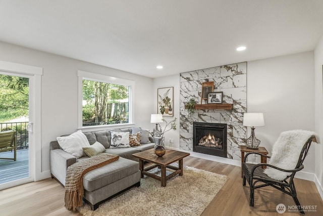 27302 NE 153rd Pl, Duvall, WA 98019 - living room featuring a large fireplace, wood finished floors, recessed lighting, and baseboards
