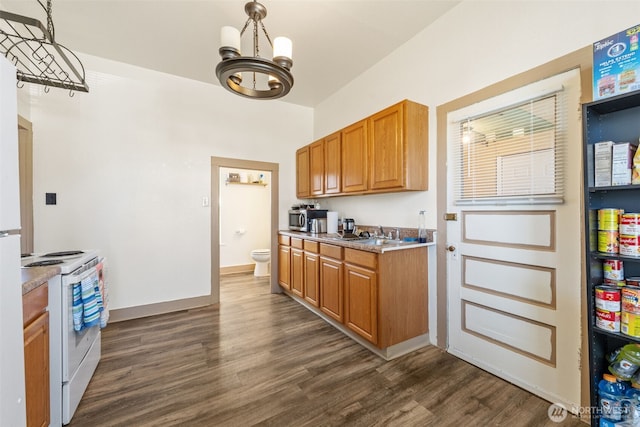 403 1st Ave S, Kent, WA 98032 - kitchen featuring white range with electric cooktop, a chandelier, dark wood-style floors, and brown cabinetry