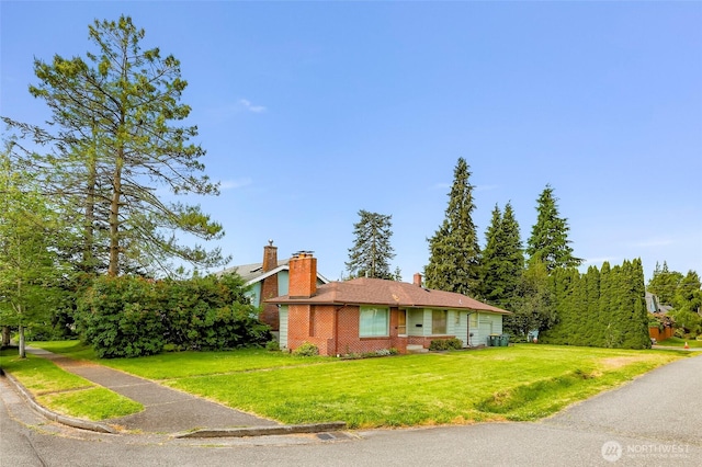 420 E Connecticut St, Bellingham, WA 98225 - view of front of property with brick siding, a front lawn, and a chimney