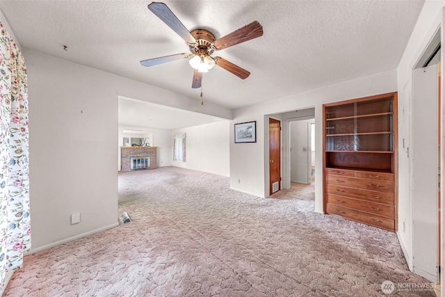 420 E Connecticut St, Bellingham, WA 98225 - unfurnished living room featuring carpet, ceiling fan, a fireplace, a textured ceiling, and baseboards