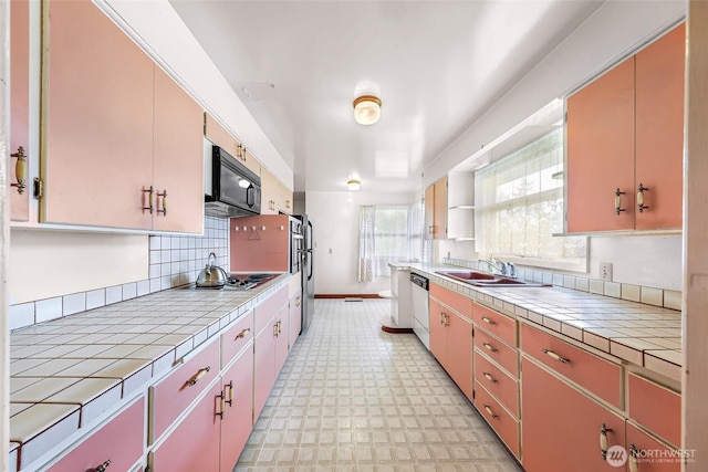 420 E Connecticut St, Bellingham, WA 98225 - kitchen with tile counters, black microwave, light floors, and dishwasher