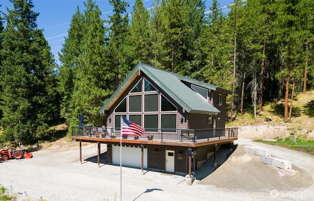 55 Wrangler Ln, Leavenworth, WA 98826 - chalet / cabin with a deck, a garage, and a view of trees