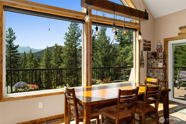 55 Wrangler Ln, Leavenworth, WA 98826 - dining room with vaulted ceiling, wood finished floors, and a mountain view