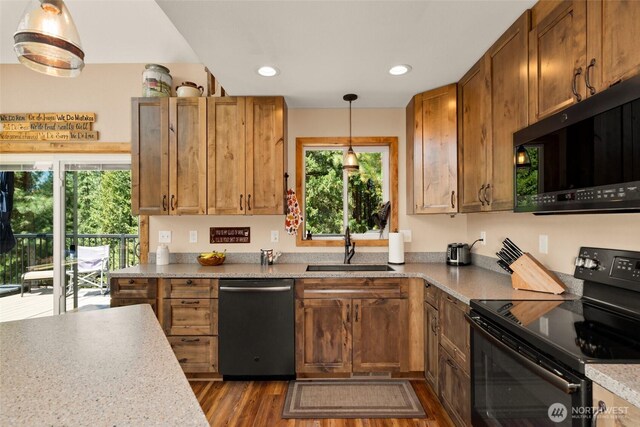 55 Wrangler Ln, Leavenworth, WA 98826 - kitchen with dishwasher, black / electric stove, a sink, dark wood finished floors, and light countertops
