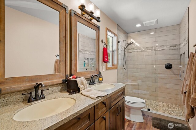 55 Wrangler Ln, Leavenworth, WA 98826 - full bath featuring toilet, a tile shower, double vanity, wood finished floors, and recessed lighting