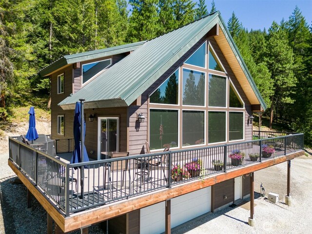 55 Wrangler Ln, Leavenworth, WA 98826 - rear view of property featuring a garage, a wooden deck, and metal roof