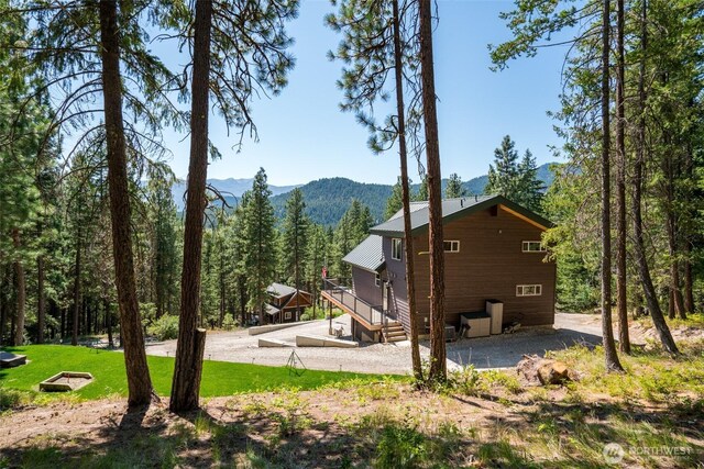55 Wrangler Ln, Leavenworth, WA 98826 - view of side of home featuring a mountain view, a forest view, and a yard