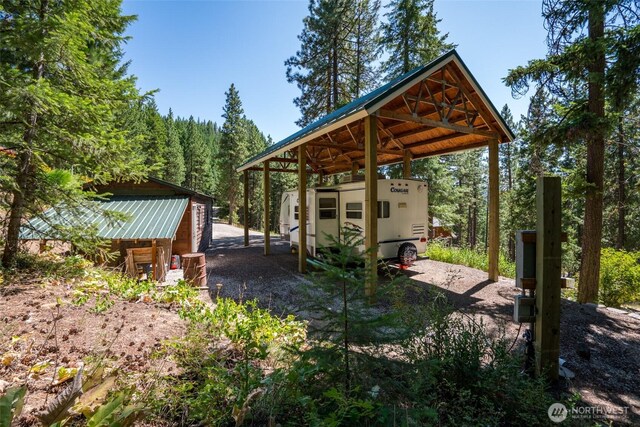 55 Wrangler Ln, Leavenworth, WA 98826 - view of patio with a carport, an outdoor structure, and dirt driveway