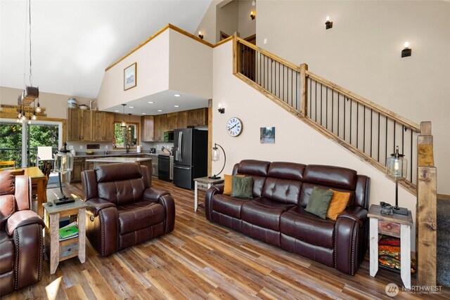 55 Wrangler Ln, Leavenworth, WA 98826 - living room with high vaulted ceiling, light wood-style floors, and stairway