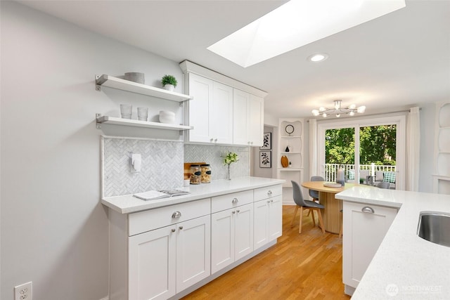 1703 NE 91st St, Seattle, WA 98115 - kitchen with a skylight, open shelves, decorative backsplash, light countertops, and recessed lighting