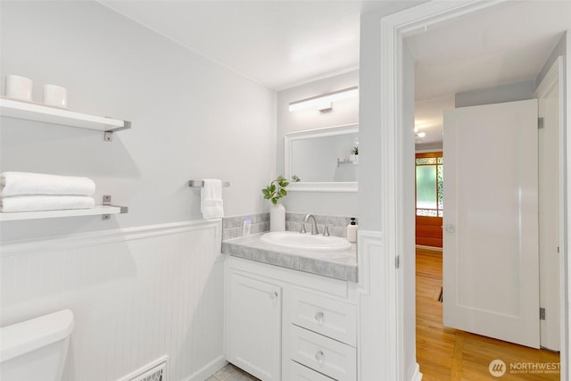 1703 NE 91st St, Seattle, WA 98115 - half bathroom featuring vanity, wood finished floors, and wainscoting