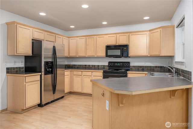 22467 SE 244th St, Maple Valley, WA 98038 - kitchen with black appliances, a sink, light brown cabinetry, a peninsula, and recessed lighting