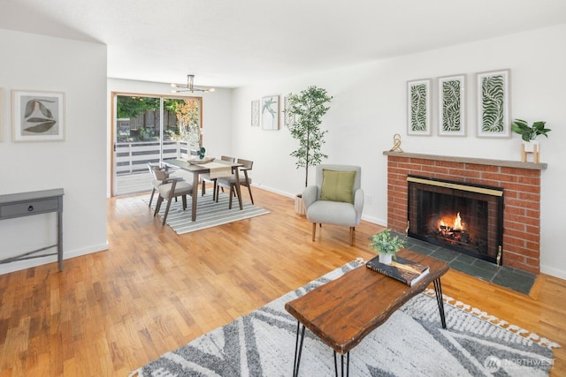 19716 81st Pl W, Edmonds, WA 98026 - living area with wood finished floors, a chandelier, and a brick fireplace