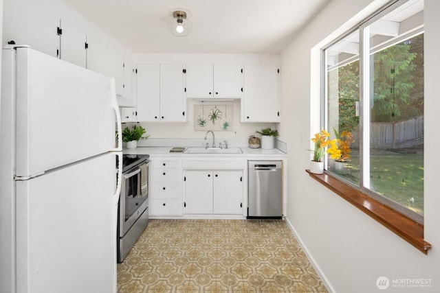 19716 81st Pl W, Edmonds, WA 98026 - kitchen with stainless steel appliances, light countertops, light floors, and white cabinets