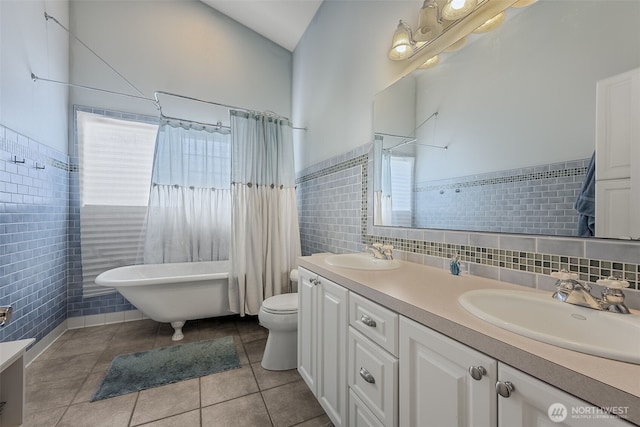 675 Bowker St SE, Lacey, WA 98503 - full bath with tile walls, double vanity, a freestanding tub, tile patterned flooring, and toilet