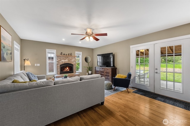 675 Bowker St SE, Lacey, WA 98503 - living area featuring wood finished floors, a ceiling fan, french doors, a fireplace, and recessed lighting