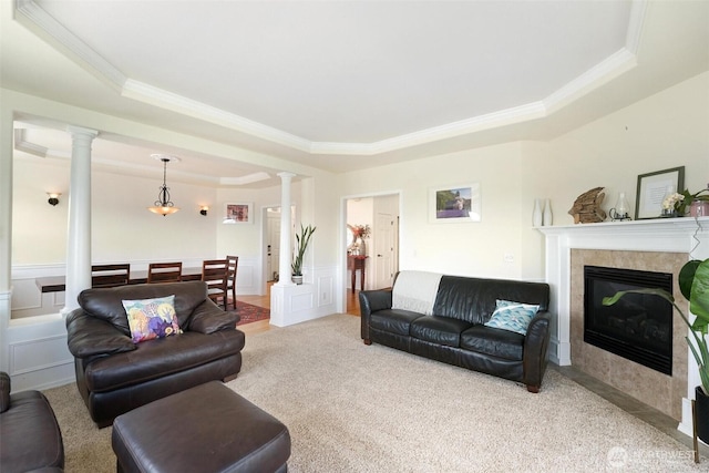 1048 Cassius Ct, Camano Island, WA 98282 - living room featuring crown molding, a raised ceiling, decorative columns, a decorative wall, and carpet