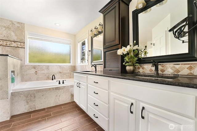 1048 Cassius Ct, Camano Island, WA 98282 - full bath featuring double vanity, a garden tub, wood finished floors, and tasteful backsplash