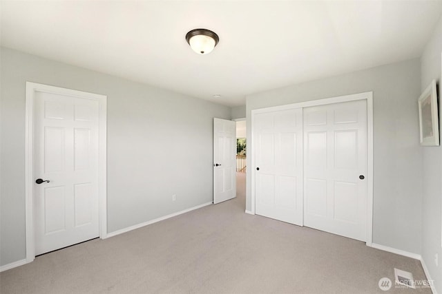 1048 Cassius Ct, Camano Island, WA 98282 - unfurnished bedroom featuring light colored carpet, baseboards, and a closet
