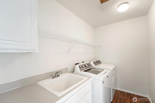 1048 Cassius Ct, Camano Island, WA 98282 - washroom featuring a sink, washing machine and dryer, dark wood-style floors, and baseboards