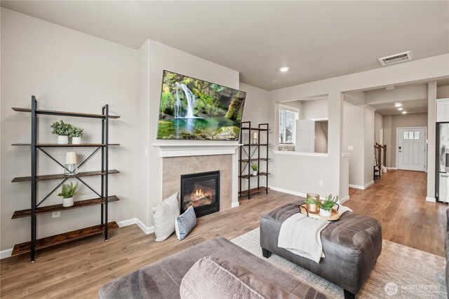 25701 204th Pl SE, Covington, WA 98042 - living area featuring wood finished floors, a fireplace, baseboards, and recessed lighting
