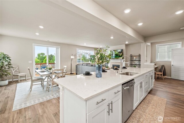 25701 204th Pl SE, Covington, WA 98042 - kitchen featuring a sink, stainless steel dishwasher, a kitchen island with sink, white cabinets, and light wood-style flooring