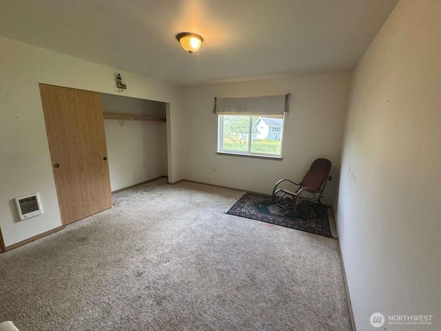 368 Snahapish Ave SE, Ocean Shores, WA 98569 - unfurnished bedroom with light carpet, a closet, heating unit, and baseboards