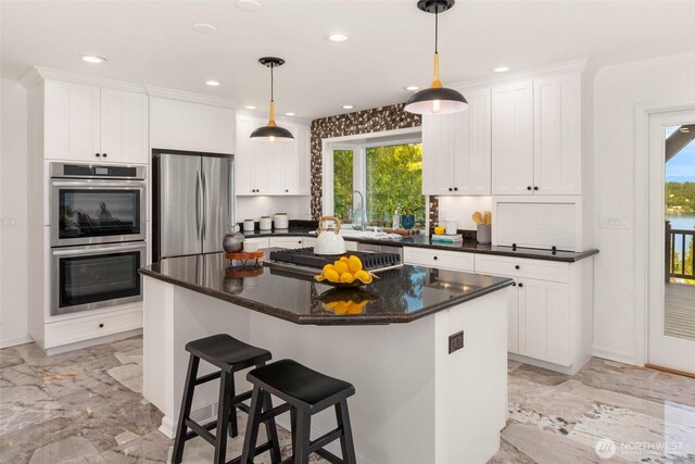 16822 SE 26th St, Bellevue, WA 98008 - kitchen with stainless steel appliances, light marble finish flooring, white cabinetry, and recessed lighting