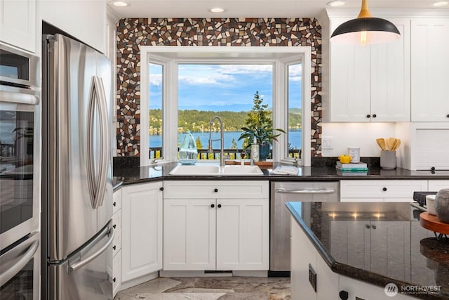 16822 SE 26th St, Bellevue, WA 98008 - kitchen with appliances with stainless steel finishes, a sink, white cabinets, dark stone countertops, and recessed lighting