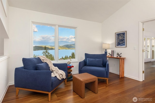 16822 SE 26th St, Bellevue, WA 98008 - sitting room with wood finished floors, baseboards, a water view, and lofted ceiling
