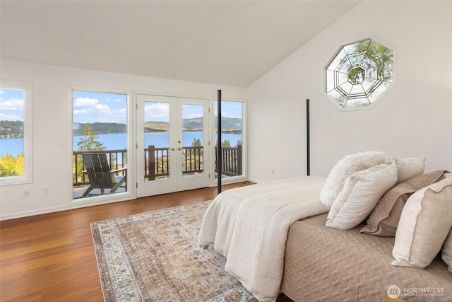 16822 SE 26th St, Bellevue, WA 98008 - bedroom with french doors, access to outside, lofted ceiling, a water view, and wood finished floors