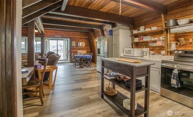 568 Cowlitz Ct SW, Ocean Shores, WA 98569 - kitchen with stainless steel appliances, open shelves, wooden walls, light countertops, and wood ceiling with exposed beams