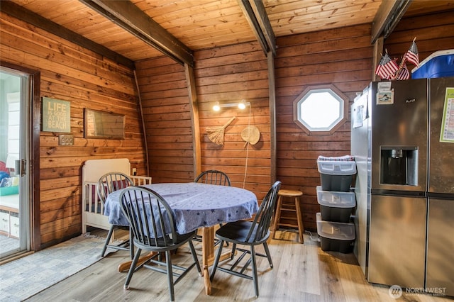 568 Cowlitz Ct SW, Ocean Shores, WA 98569 - dining space featuring light wood finished floors, wood ceiling with exposed beams, and wood walls